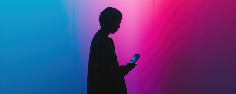 A silhouette of a teenager using cellphone.