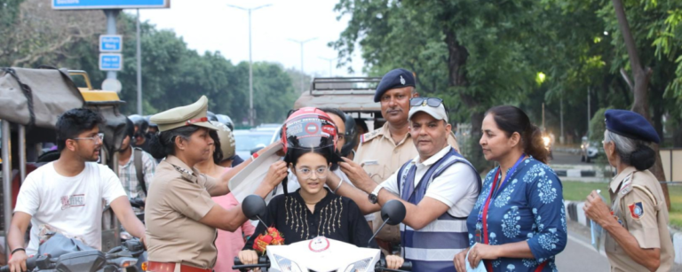 Picture of Chandigarh Traffic Police making a rider wear helmet as part of road safety.