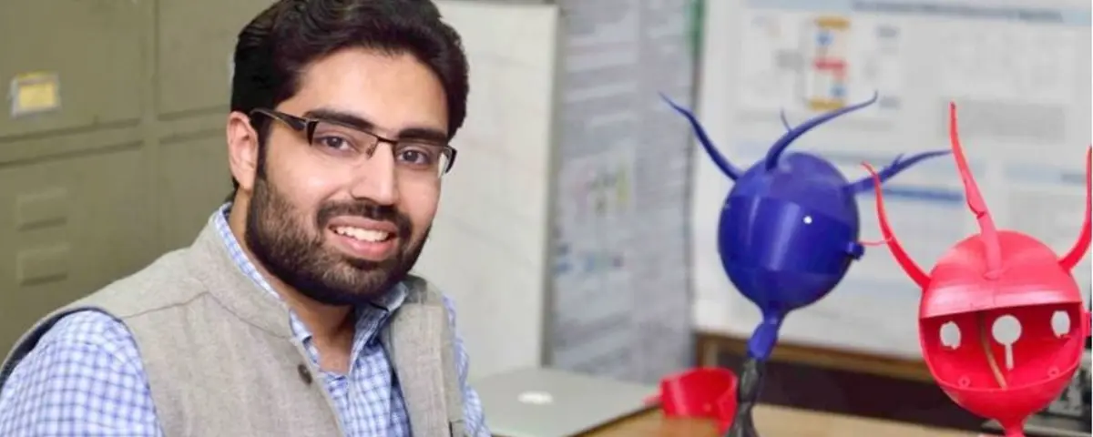 Manan Suri, founder of CYRAN AI, seated in his IIT-Delhi lab beside 3D-printed neuron models