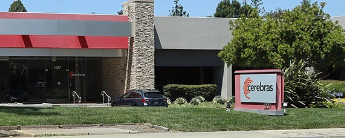 Exterior view of Cerebras Systems' headquarters in Sunnyvale, California, with the company's logo displayed on a sign outside the office building.