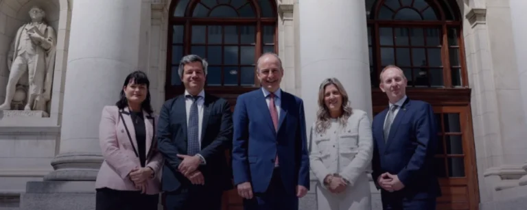 Group of officials, including Irish Prime Minister Micheál Martin and OpenAI representatives, pose for a photograph outside a government building in Dublin.