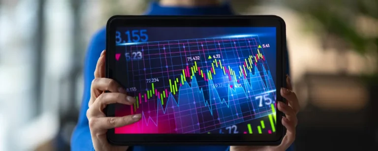 A person holding a tablet that symbolically shows stock markets.