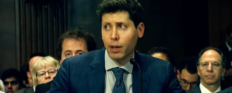 Sam Altman testifying at a US congressional hearing, seated in a dark suit and blue tie in front of a microphone
