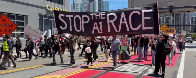 Protestors carry a large black Stop the AI Race banner while marching through a San Francisco street on July 11