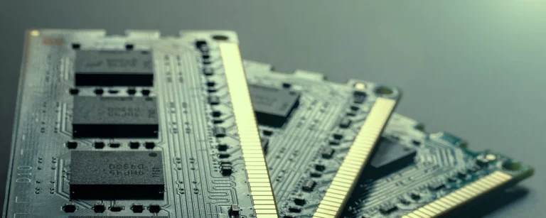 Close-up of stacked High Bandwidth Memory (HBM) modules, showing exposed memory chips and gold connector contacts.