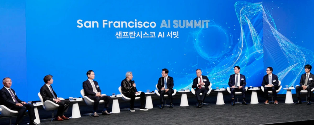 Panel discussion at the San Francisco AI Summit with South Korean President Lee Jae Myung and tech executives seated on stage in front of a blue "San Francisco AI Summit" backdrop.