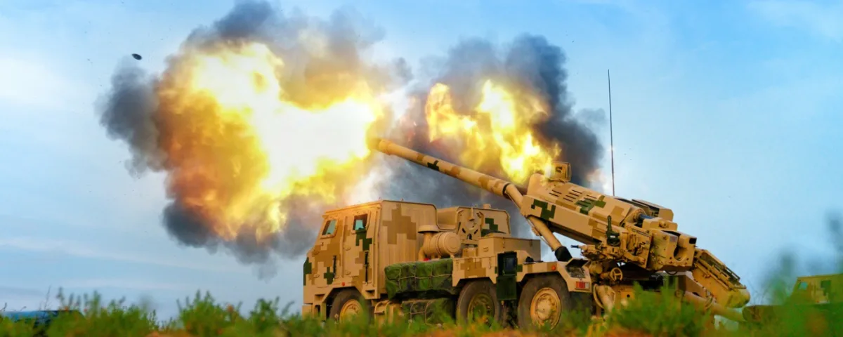 Chinese Military Used US AI Models to Build Defense Tech Chinese PLA artillery system firing during live military exercise with smoke and flame