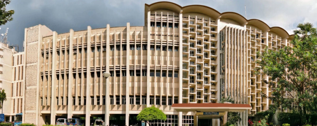 IIT Delhi campus building with a large multi-storey academic block and landscaped surroundings.