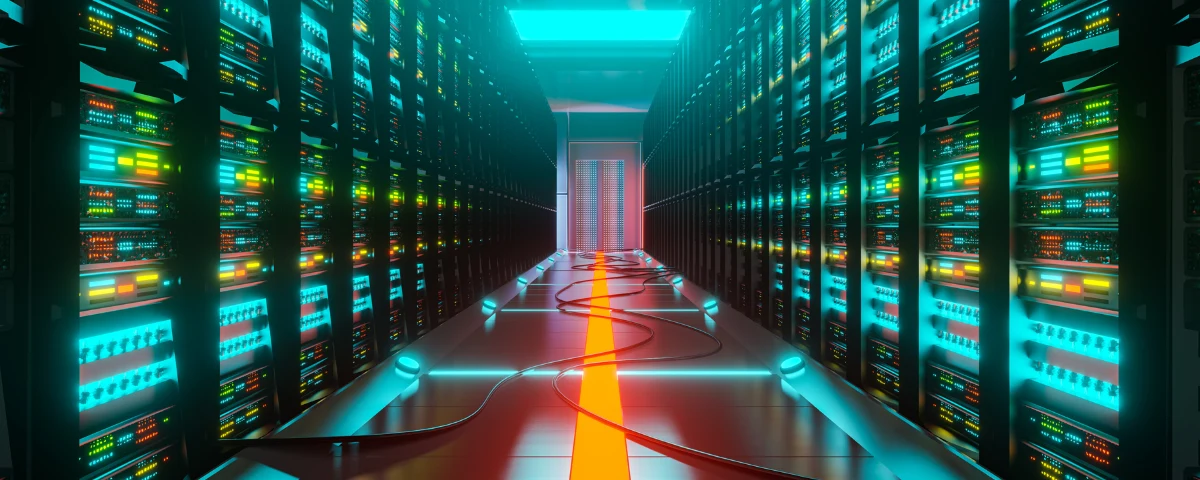 Rows of illuminated server racks in a data centre corridor, representing India's sovereign AI compute infrastructure.
