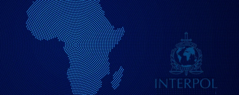 Dotted map of Africa beside the INTERPOL logo on a dark blue background