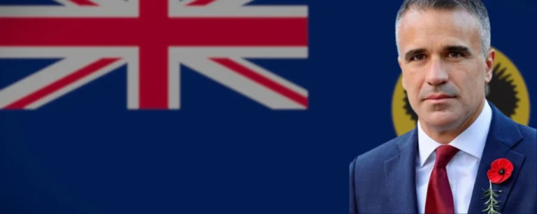 South Australian Premier Peter Malinauskas pictured against the South Australian and Australian flags.