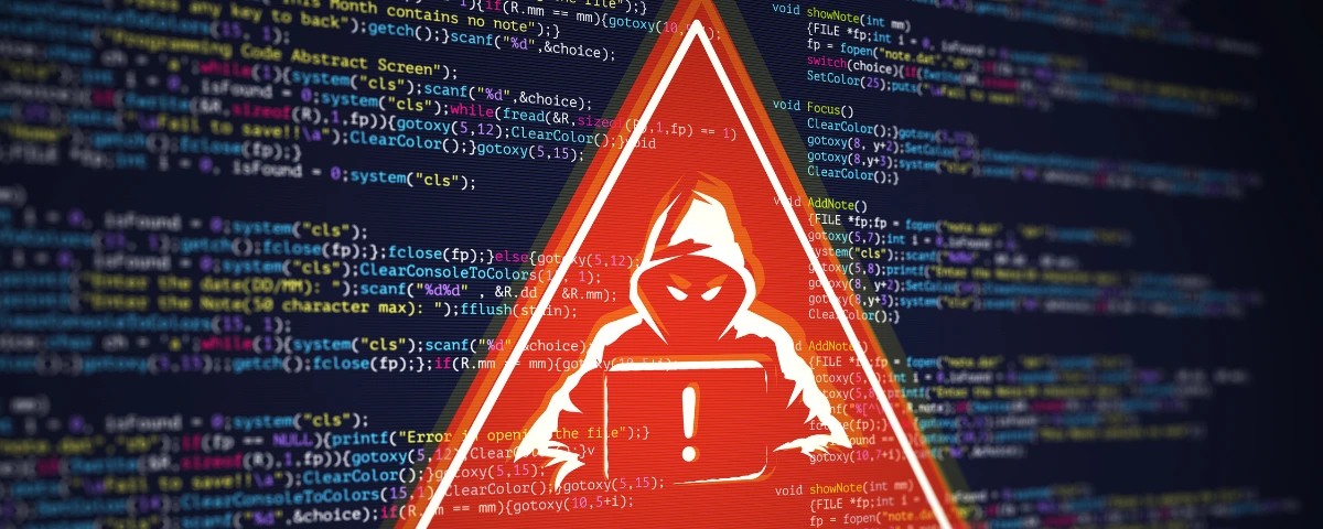 Red warning triangle featuring a hooded hacker and exclamation mark over a blurred background of computer code.