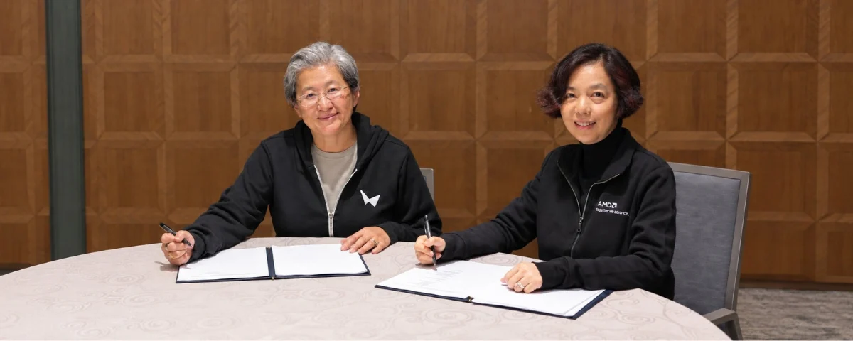 AMD CEO Lisa Su and World Labs co-founder Fei-Fei Li signing documents during AMD’s $8.2 billion acquisition of World Labs