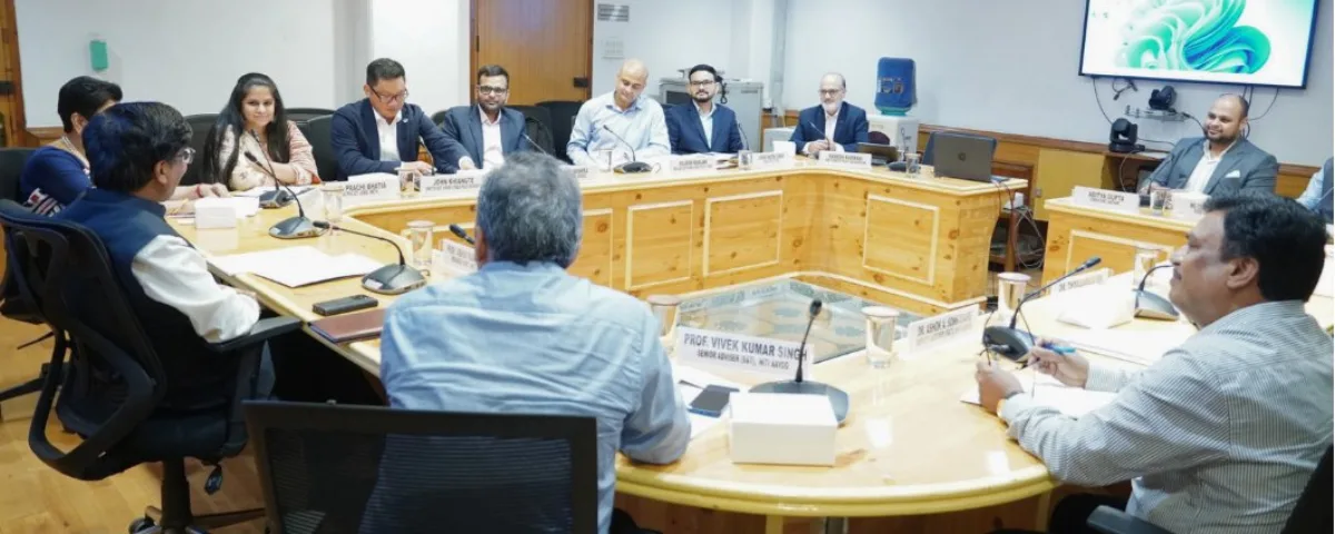 India NITI Aayog Holds Closed Door Meet with US Tech Companies Over AI Policy and Governance Officials seated around a wooden conference table in a New Delhi meeting room during NITI Aayog’s closed-door discussion with US tech company representatives on AI governance.
