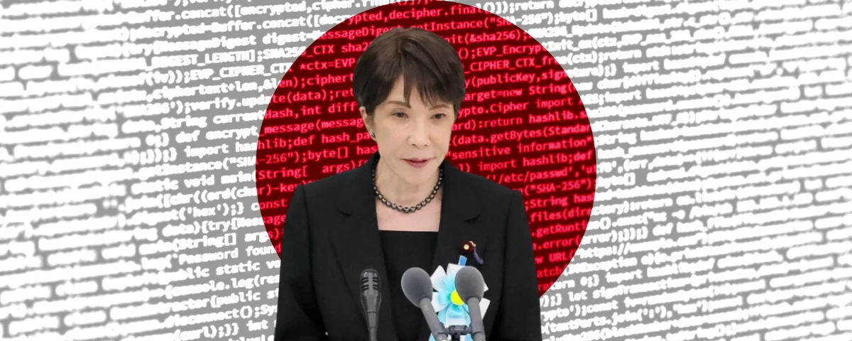 Japanese Prime Minister Sanae Takaichi, wearing a black jacket and pearl necklace, speaks at a podium with two microphones against a background of scrolling computer code in white and red.