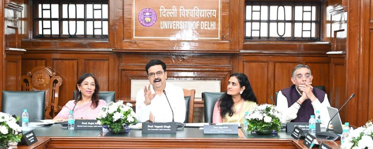 Delhi University and AMD officials seated at a conference table during the collaboration announcement, with DU Vice-Chancellor Prof. Yogesh Singh and AMD India Country Head Jaya Jagadish among those present.