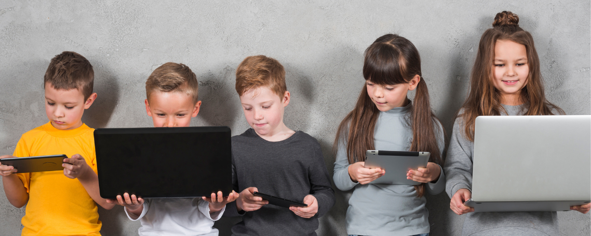 Five children using smartphones, tablets and laptops, representing young users’ exposure to social media, AI and digital platforms.
