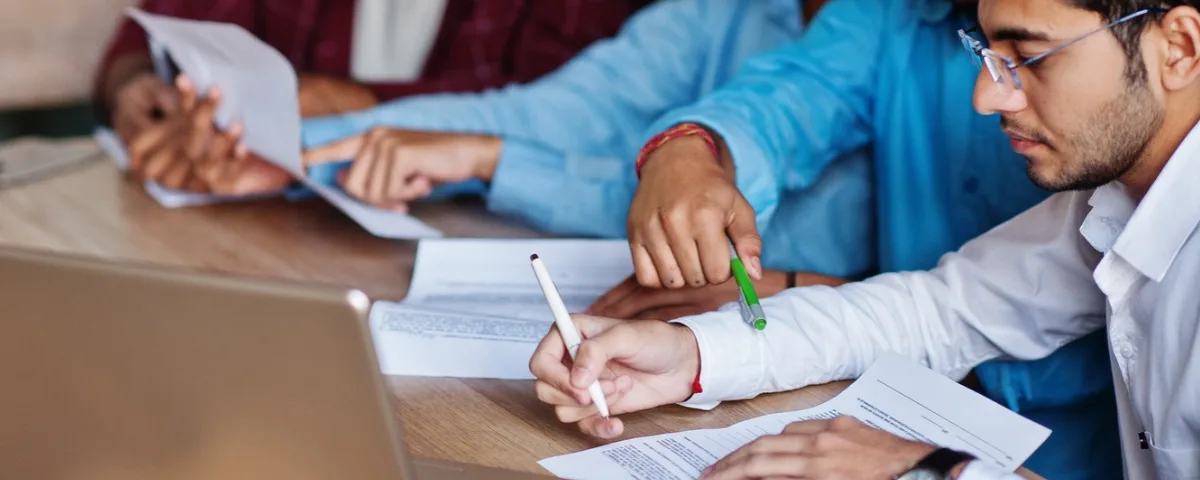Office employees reviewing documents as AI automation reshapes entry-level jobs in India.