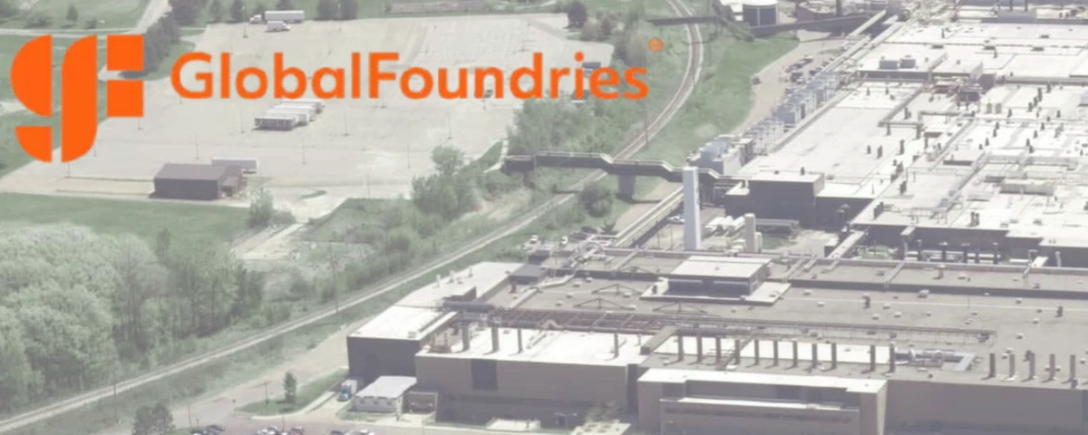 Aerial view of a GlobalFoundries semiconductor manufacturing facility, with the company’s logo displayed in the upper-left corner.