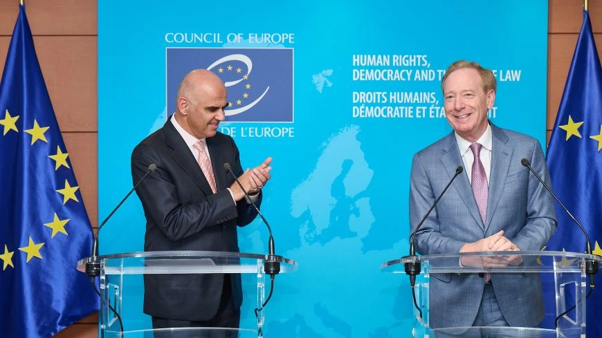 Council of Europe Secretary General Alain Berset and Microsoft President Brad Smith stand at podiums during an event at the Council of Europe headquarters in Strasbourg.