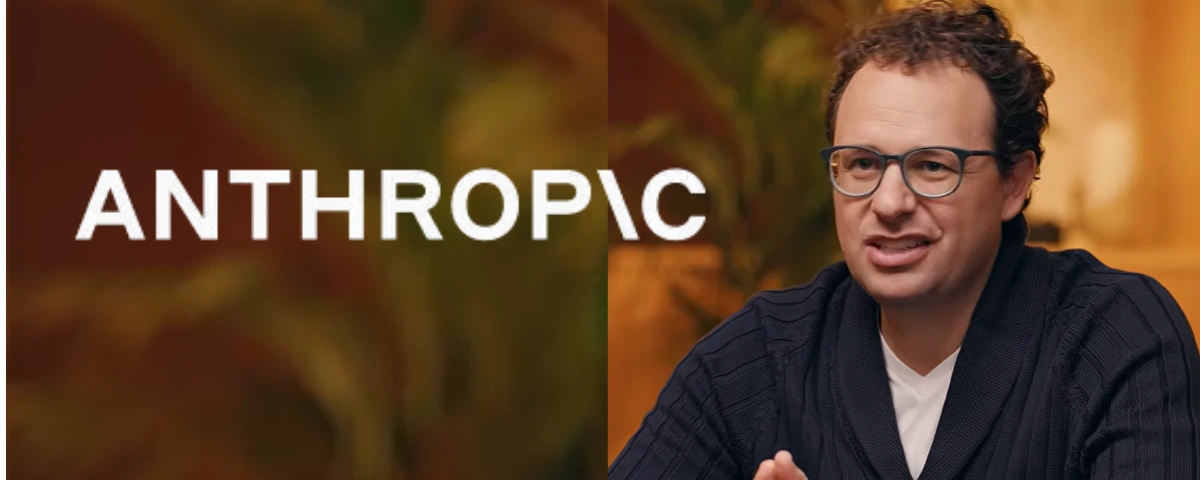 Anthropic CEO Dario Amodei seated beside the Anthropic logo.